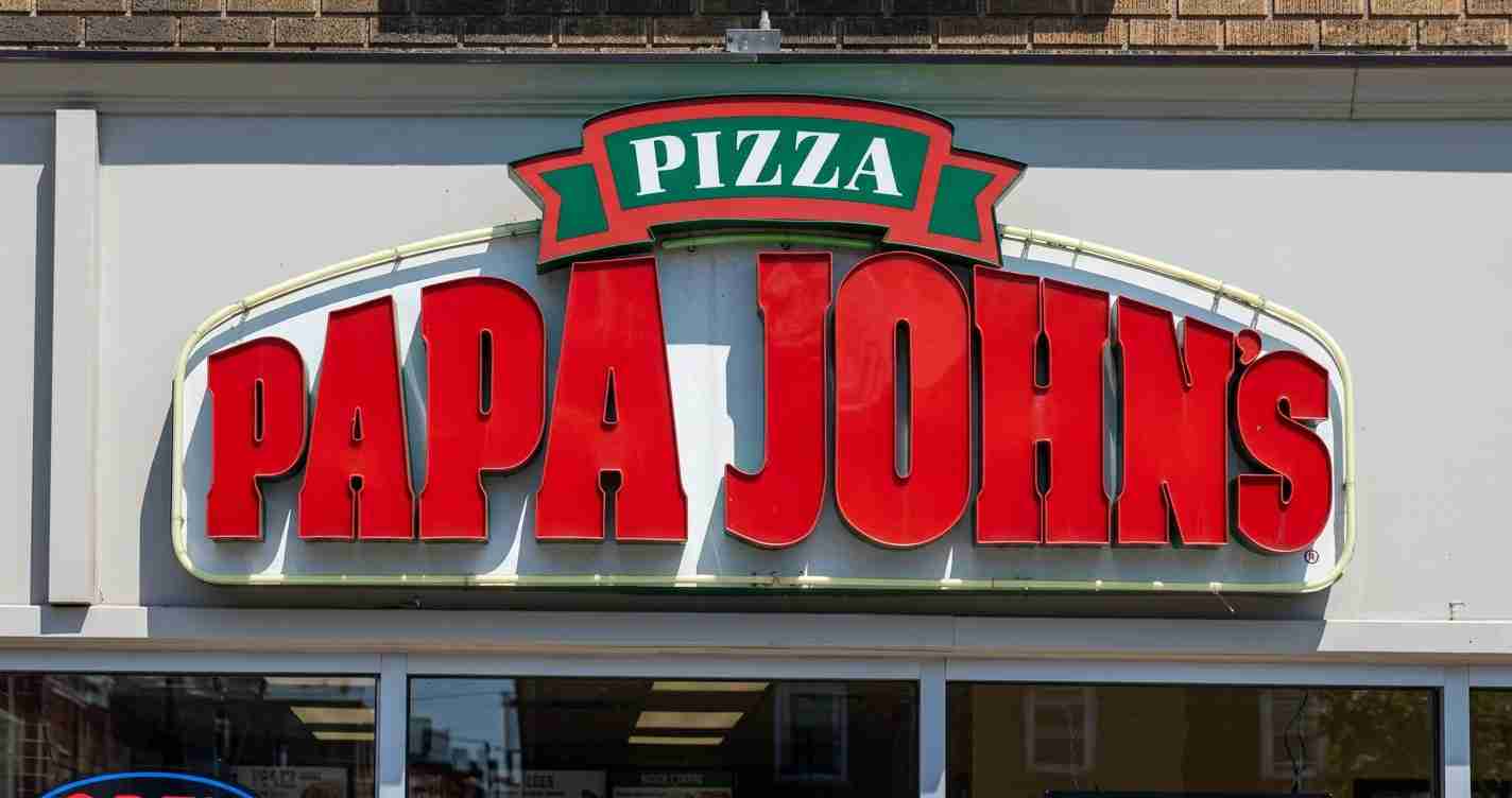 Papa John's pizza storefront sign with a green PIZZA banner above the red logo.